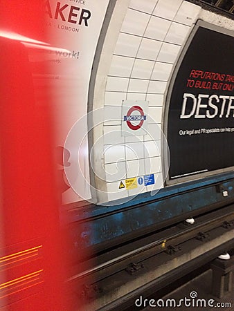 The Underground Tube Train arriving at Victoria Station, London Editorial Stock Photo