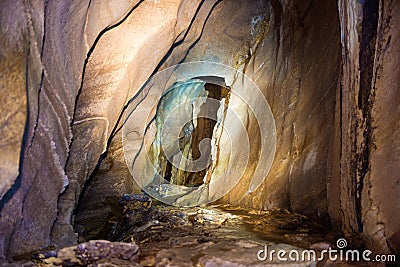 Underground tunnel inside dark natural cave Stock Photo