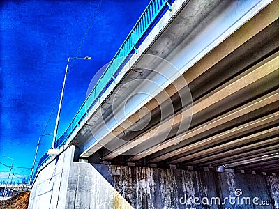 Underpass Structure Showing Concrete Beams and Support Columns. Underneath a highway overpass with visible beams and Stock Photo