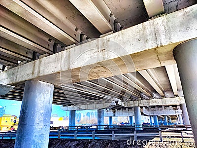 Underpass Structure Showing Concrete Beams and Support Columns. Underneath a highway overpass with visible beams and Stock Photo