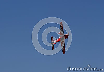 Underside of red Model Airplane Flying Editorial Stock Photo