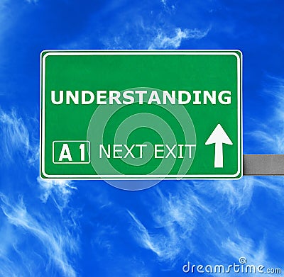 UNDERSTANDING road sign against clear blue sky Stock Photo