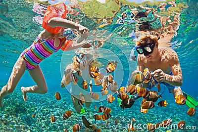 Underwater photo. Happy family snorkelling in tropical sea Stock Photo