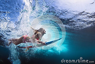 Underwater photo of girl with board dive under ocean wave Stock Photo