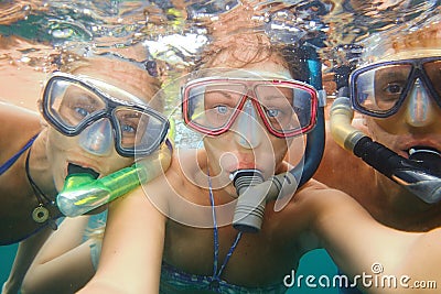 Underwater photo of a young people snorkeling at tropical ocean Stock Photo