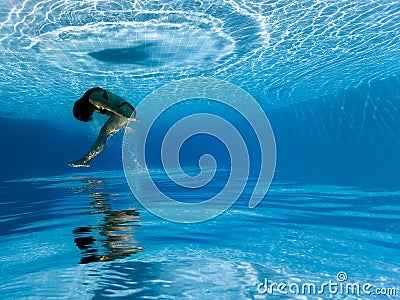 Underwater photograph : Woman jumping in pool Stock Photo