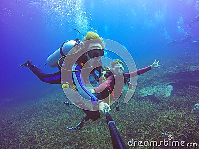 Underwater scuba diving selfie shot with selfie stick. Deep blue sea. Stock Photo