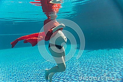Underwater shot of beautiful pregnant woma Stock Photo