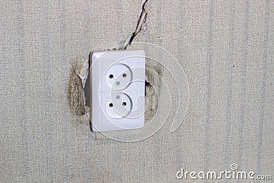 Undone AC power socket in wall. Repairs in the apartment Stock Photo