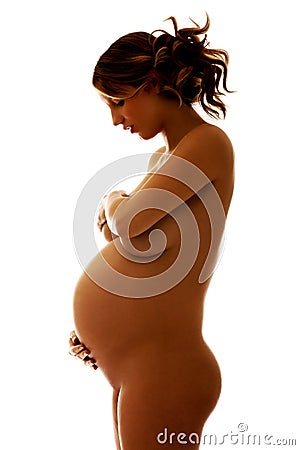 Undressed pregnant woman covering her breast Stock Photo