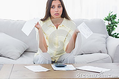 Uneasy woman doing her accounts Stock Photo