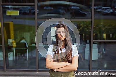 Unemotional young woman looking at the camera Stock Photo