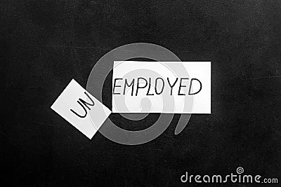 Unemployed - employed - torn paper sheet on black background top view. Hiring concept. Stock Photo