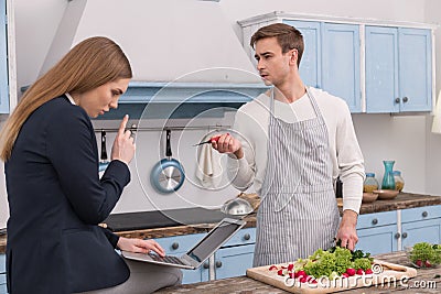 Unemployed husband preparing dinner for his wife Stock Photo