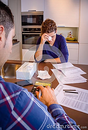 Unemployed husband reviewing the bills and wife Stock Photo