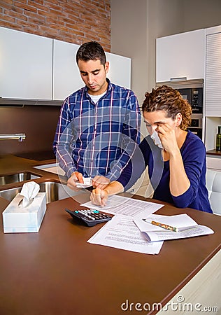 Unemployed husband reviewing the bills and wife Stock Photo