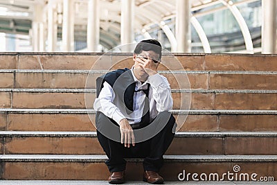 Unemployed stressed young Asian business man suffering from severe depression. Failure and layoff concept Stock Photo