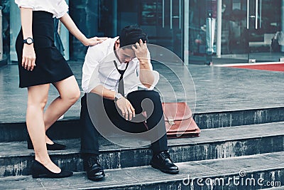 Unemployed Tired or stressed businessman sitting on the walkway Stock Photo