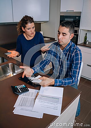 Unemployed young couple with debts reviewing their Stock Photo
