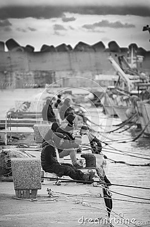 Unemployed young man fishing Editorial Stock Photo