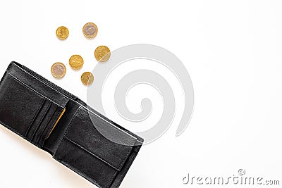 Unemployment concept. Lack of money. Coins fall out of wallet on white background top view copy space Stock Photo