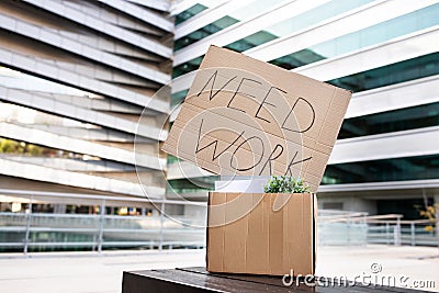 Unemployment Concept. Placard With Need Work Text Put In Box With Belongings Stock Photo