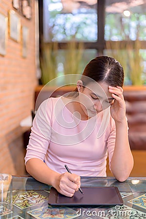 Unemployment and Mental health problem. Corona virus job losses in Asia. Thai businesswoman looking for new job on website. Stock Photo