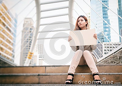 Unemployment. businesswoman with sign looking for a job. Stock Photo