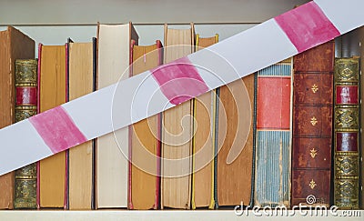 Unequal educational opportunities, books and barrier tape, symbol Stock Photo