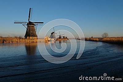 UNESCO World Heritage windmills stand as waters are partially frozen in Kinderdijk, near Rotterdam Netherlands Stock Photo