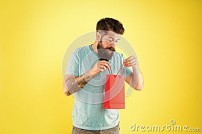 Unexpected surprise. little pleasantness. bearded man go shopping. store for men. mature male with purchase. surprised Stock Photo