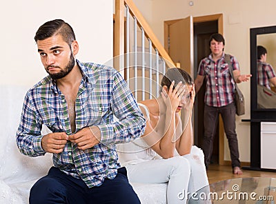 Unfaithfulness: blushed and looked away spouse caught by surprise Stock Photo