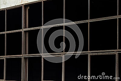 Unfilled tape glazing of an abandoned industrial building close-up Stock Photo