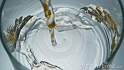 Unfiltered drink jet pouring glass closeup. Craft intoxicant beer filling vessel Stock Photo