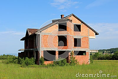 Unfinished brick family suburban house without doors or windows Stock Photo