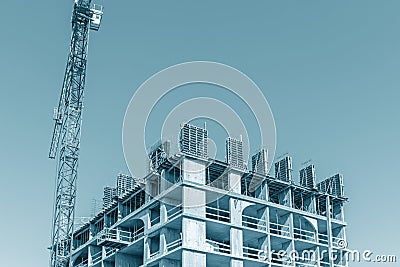 Unfinished building with falsework against blue sky background Stock Photo