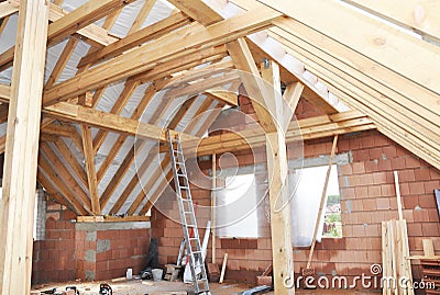 Unfinished House Attic Construction Interior. Building house attic room with roofing wood trusses, frame, wooden beams. Stock Photo