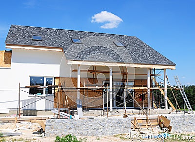 Unfinished house. Home Remodeling and Renovation. Painting house wall with stucco and plastering. Insulation House Wall Stock Photo