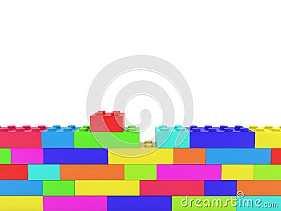 Unfinished wall of colorful toy bricks on white Stock Photo