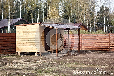 Unfinished wooden barn with shed Stock Photo