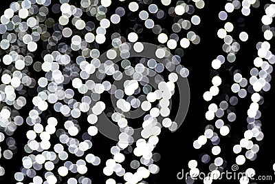 Unfocused abstract white bokeh on black background. defocused and blurred many round light Stock Photo