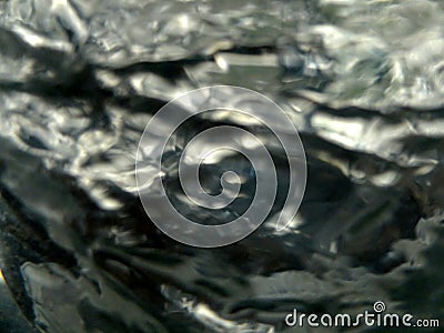 Unfocused blurred silver rotating turbulent liquid for background or texture Stock Photo