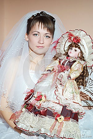 Unfortunate bride holding a beautiful doll Stock Photo