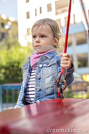 The unfortunate little girl on the playground Stock Photo