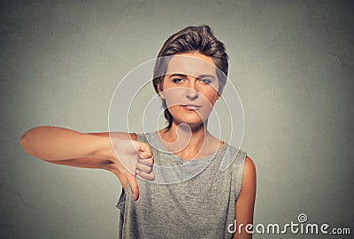 Unhappy, angry, off woman, annoyed giving thumbs down gesture Stock Photo