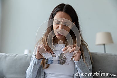 Unhappy angry woman tearing picture, divorce and relationship problem Stock Photo