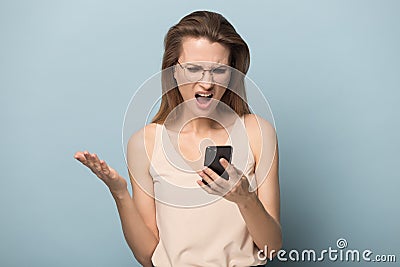 Unhappy angry woman using phone, reading bad news Stock Photo