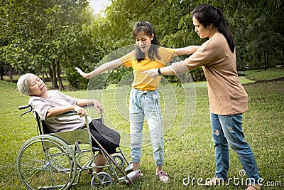 Unhappy asian teen granddaughter set apart,dissuade her family,angry senior mother and aggressive daughter arguing violently, Stock Photo