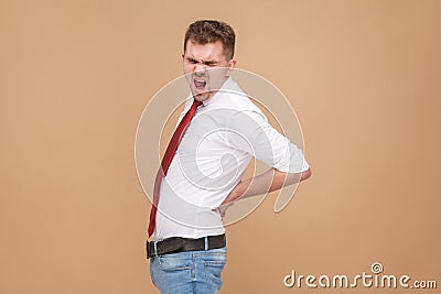 Unhappy businessman have spine pain or ill kidneys Stock Photo