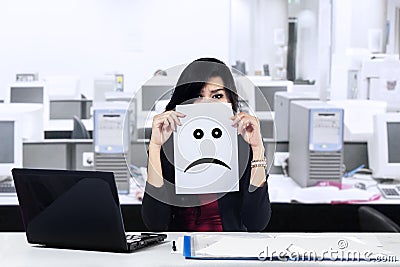Unhappy businesswoman in the office Stock Photo